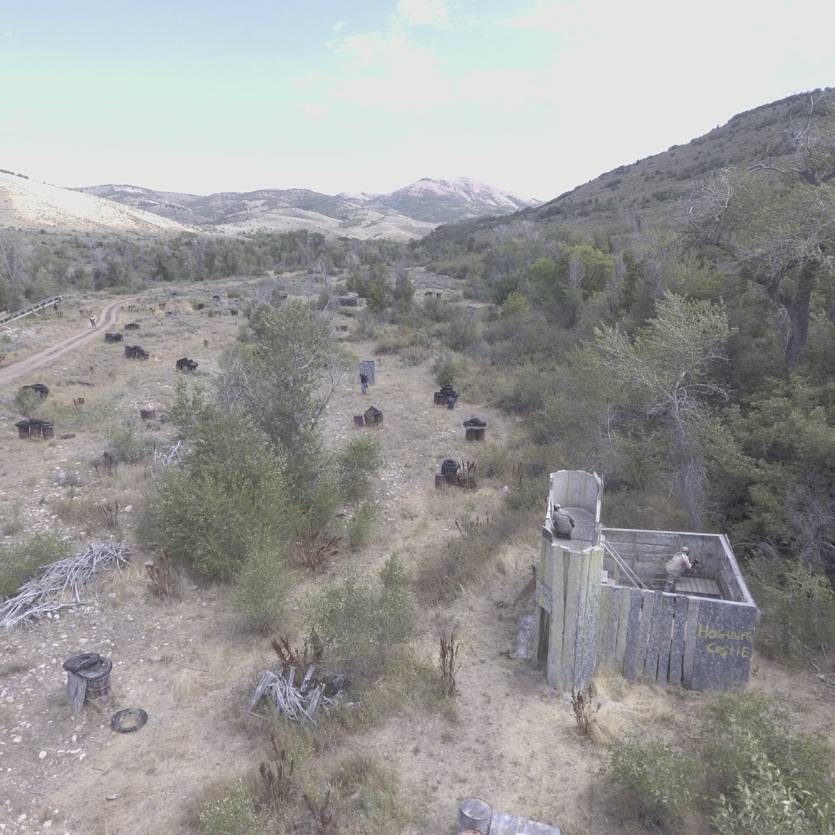Hogwarts castle themed paintball field at Action Center Paintball in Utah where players battle around a large castle structure during outdoor scenario paintball games.